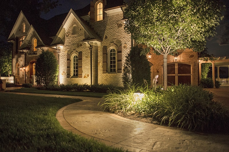 Front walkway and yard of a house lit by CAST Landscape lighting